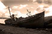 Wrecked trawlers on the shoreline in Salen Bay on the Isle of Mull, Argyll, Scotland