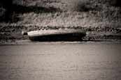 A wrecked hull on the shoreline at Badachro, Wester Ross, Scotland