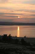 The winter sun setting over Badachro on the south shore of Loch Gairloch, Wester Ross, Scotland